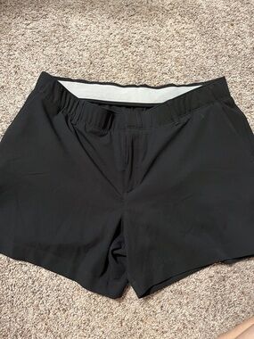 Black womens Under Armour gold shorts.